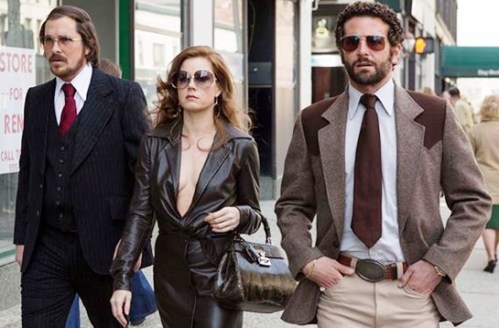 Christian Bale, Amy Adams, and Bradley Cooper strut in 'American Hustle'