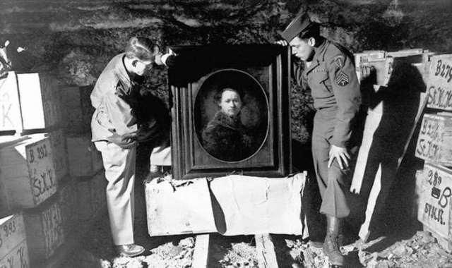 A couple of the actual Monuments Men with a stolen Rembrandt found in a German salt mine.