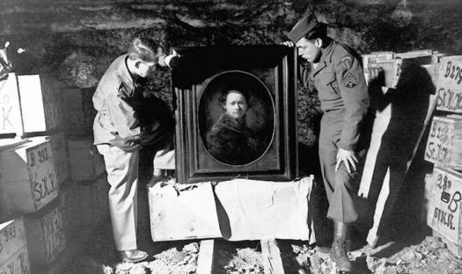 A couple of the actual Monuments Men with a stolen Rembrandt found in a German salt mine.